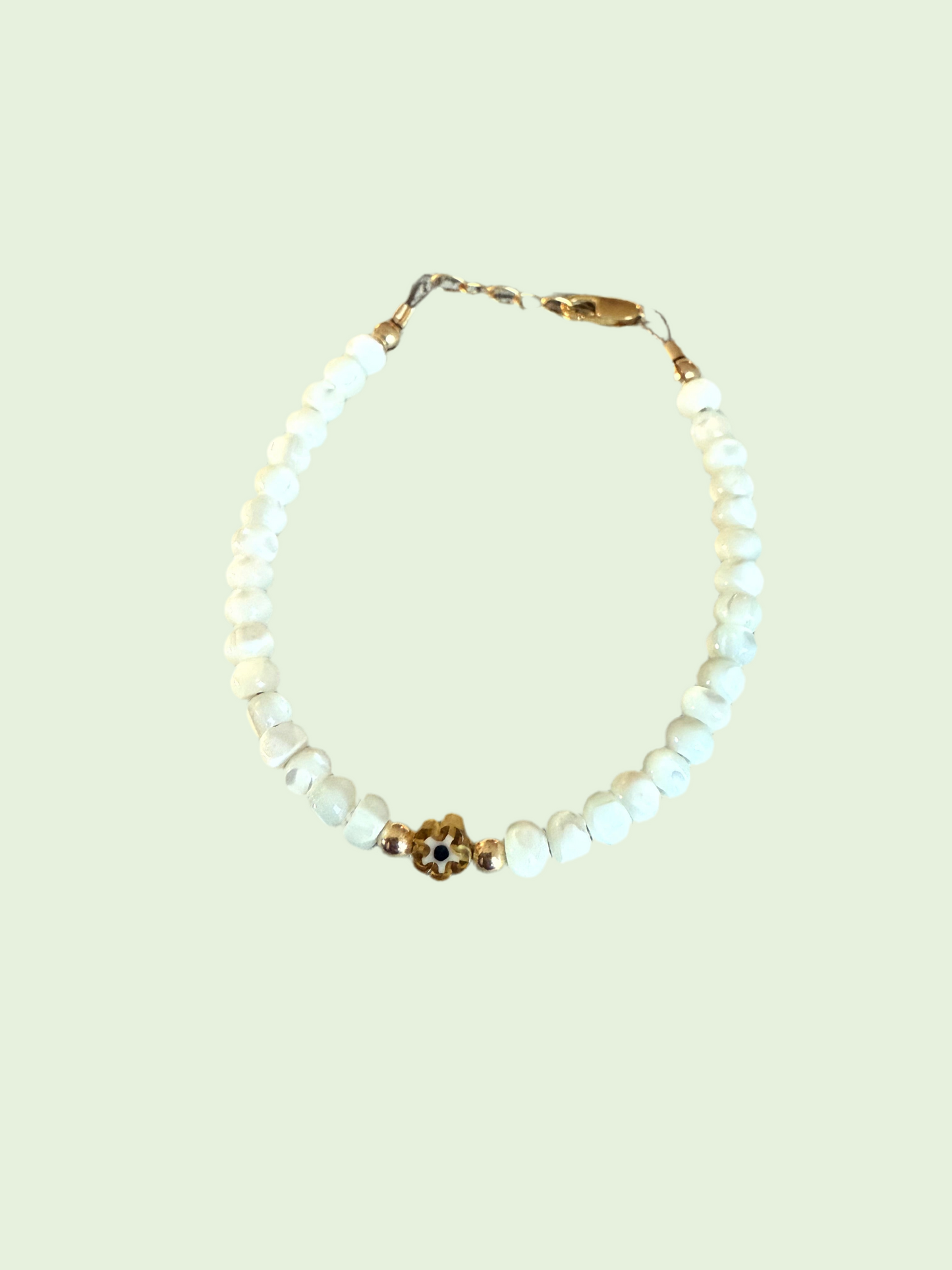 White beaded bracelet with amber flower